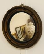A Regency style, convex porthole style mirror. (AF)