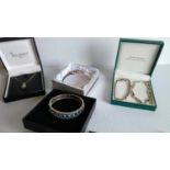 An assortment of two silver bangles, two bracelets, necklace all mounted with various gemstones (5)