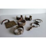 An assortment of white metal tribal bangles, pendants, chains, etc