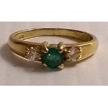 An 18ct yellow gold emerald ring with diamond shoulders, size H, 2.74g and a gold plated double