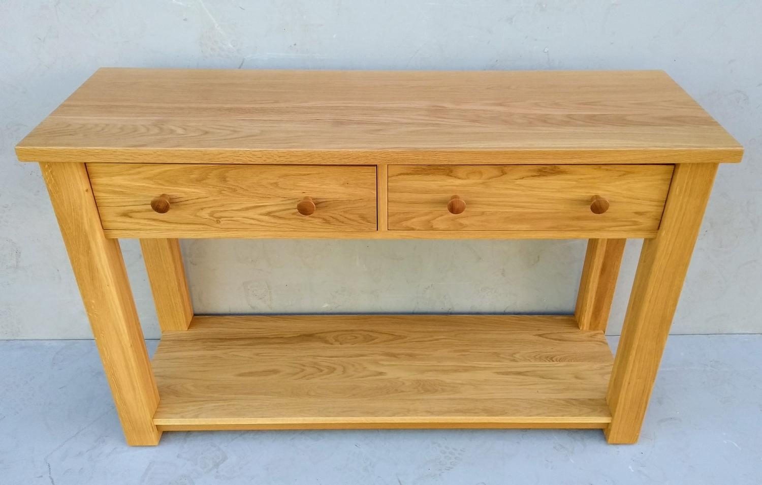 A contemporary light solid oak consul table with frieze drawers, 7 7H x 122 W x 40 cm D (legs 7x7