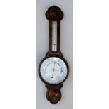 An Edwardian oak-framed aneroid banjo-shape barometer