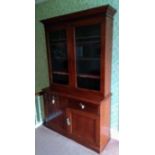 A 19th century walnut bookcase with shaped cornice, twin glazed doors, shelved interior, two