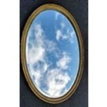 An Edwardian oval gilt-framed wall mirror, 110 x 80 cm. Condition: repair / filler to one side (