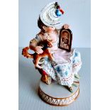 A 19th century Meissen group of a seated lady with dog and mirror. Cross swords mark in blue to base