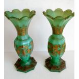 A pair of 19th century Bohemian green glass baluster vases with wavy rims and painted gilt