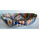A late 19th century Chinese Imari oval bowl with multi-coloured lobed decoration with four character