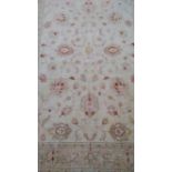 A Ziegler ivory-ground hand-knotted Pakistani wool rug with multicoloured floral decoration, wide