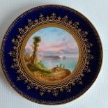 A pair of Regency Spode dessert plates with landscapes surrounded by floral gilt decoration, each