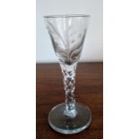 A Georgian wine glass with etched lily of the valley decoration, faceted stem on a conical base,