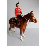 **PLEASE NOTE: BACK LEG OF HORSE IS DAMAGED***A Beswick figurine of H.M. Queen Elizabeth II