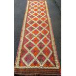 A Suzani hand-knotted Kilim wool runner with multicoloured decoration, 283 x 76 cm in good