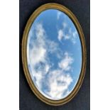 An Edwardian oval gilt-framed wall mirror, 110 x 80 cm. Condition: repair / filler to one side (