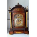 A Victorian rosewood-cased three-train bracket clock with brass marquetry decoration, silvered dial,