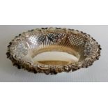 A Victorian silver pierced oval bon-bon dish with elaborate rococo decoration by Fenton Brothers,