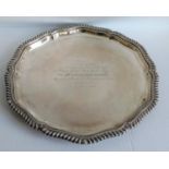 A George V silver salver with gadroon edge on three bun feet by William Hutton & Sons Ltd,