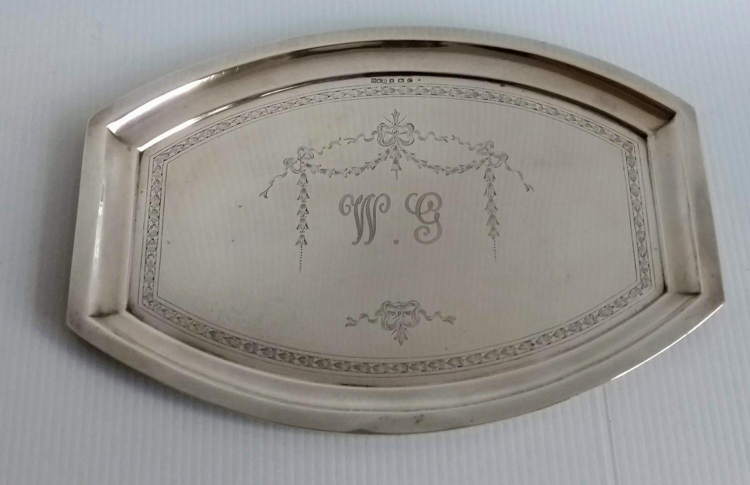 An Art Deco silver sandwich tray decorated with incised festoons, initialled, by Deykin &