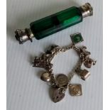 A Victorian double-ended green glass faceted scent bottle and a silver charm bracelet (2)