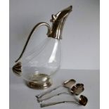 An Art Deco claret or wine jug in the shape of a duck with silver plated mounts on a stepped base