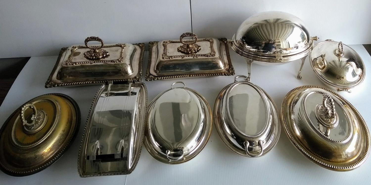 An assortment of silver plated entree dishes, food warmer, etc