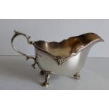 A George V silver sauce boat with cast rim on hoof feet by Adie Brothers, Birmingham, 1930, 255g.