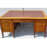 An Edwardian oak partner's desk stamped Hobbs & Co, London, with tooled leather top, over one long