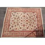 A hand-knotted ivory-ground multi-coloured wool drawing room rug with floral decoration, double