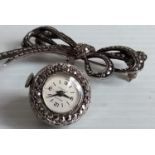 An Art Deco Swiss .925 silver and marcasite ladies brooch watch, the elaborately encrusted bow