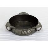 An Arts and Crafts pewter butter dish with three handles and honesty motifs by Archibald Knox for