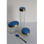A set of three Art Deco silver-topped vanity jars with blue enamel decoration by Cole Brothers,