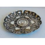 A 19th century Continental silver lobed dish with profuse rococo decoration and heraldic shield to