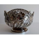 A Victorian silver table centre or smaller monteith, half-fluted with rococo decoration on a stepped