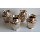 A set of four Victorian matching silver vases of baluster form with flared rims, foliate scrolls