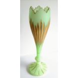 A late 19th century Bohemian opaline green glass and gilt vase with serrated rim, fluting to body,