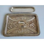 An Edwardian silver embossed tray with pie crust border, foliate and rococo decoration with vacant