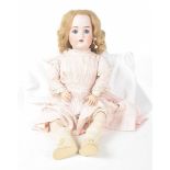 A large German bisque headed doll With light curly auburn wig, fixed blue eyes, open mouth,