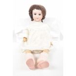 A large bisque headed doll With brown hair, open/shut brown eyes, open mouth,