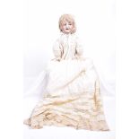 A German bisque headed doll With blonde wig, blue eyes with sideways movement,