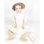 A French bisque headed doll With brown wig, fixed blue eyes, open mouth,