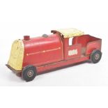 A Triang tinplate model push along train In red and yellow with black rubber wheels.