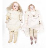 Two Continental bisque headed dolls One with blond curly wig fixed brown eyes, open mouth,