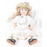 A German bisque headed doll With long blond wig, fixed blue eyes, open mouth,