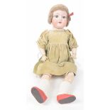 A German bisque headed doll With short brown wig, open / shut blue eyes, open mouth,