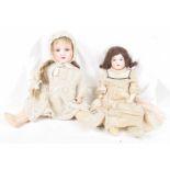 Two German bisque headed dolls by Armand Marseille Comprising doll with dark brown wig,