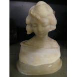 An alabaster head and shoulders bust of a young woman raised on a plinth, unsigned.