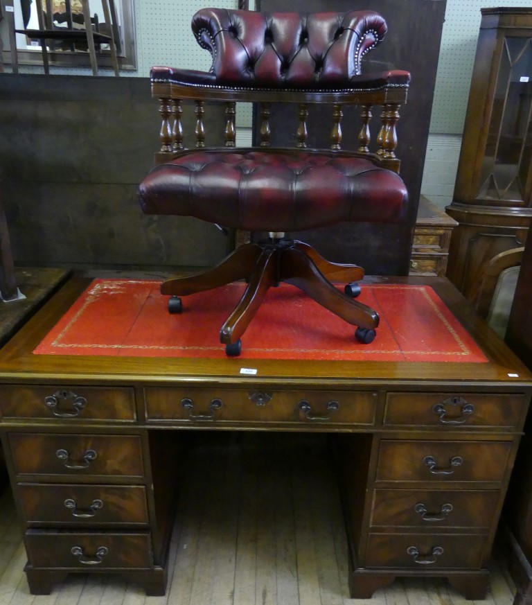 A good quality reproduction mahogany veneered flat top kneehole desk,