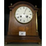 An early 20th Century mahogany cased mantel clock, presentation inscription dated April 1915.