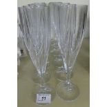 Twelve modern clear glass champagne flutes