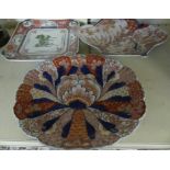 A collection of three Imari pattern dishes, to include one with central lotus flower.