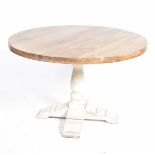 A rustic hardwood circular pedestal kitc